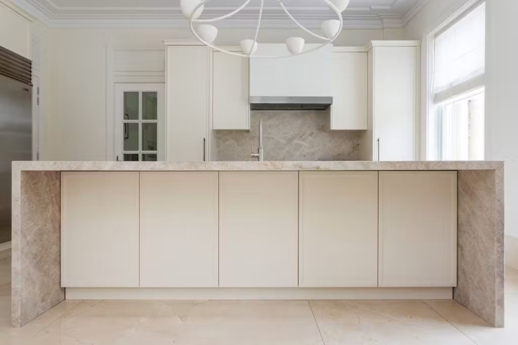 Split Pines — cream island kitchen with Crittall window